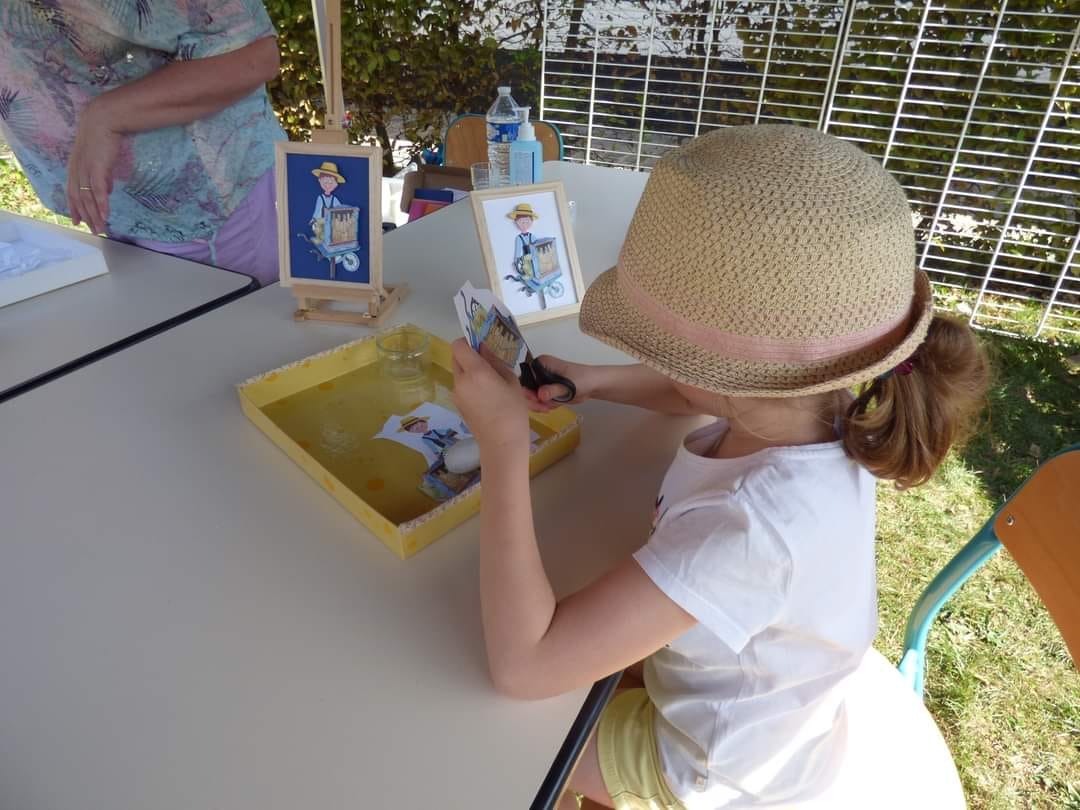 petite fille au chapeau découpant avec l'atelier les papillons apprivoises